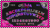 A stamp of a ouija board with the letters on the board flashing and changing colour between pink, purple and grey. The stamp has a dark pink border.